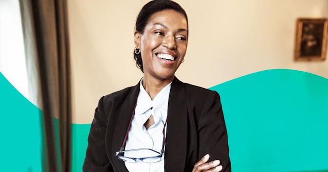 female law professional with arms crossed standing at law firm
