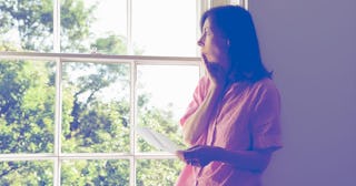 Woman with letter by window