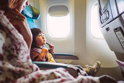 little girl wearing the headphone looking at the seat