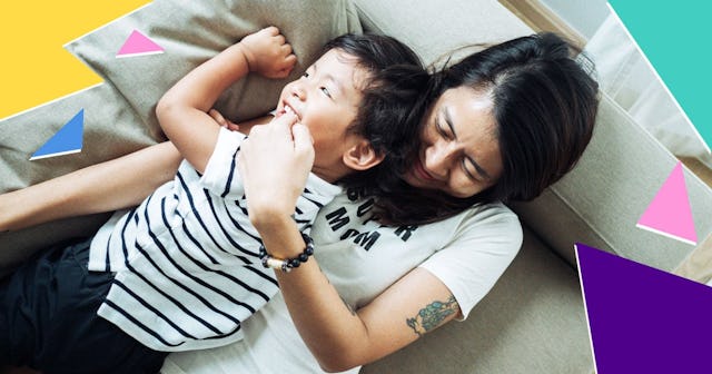 Directly above shoot of cute baby and mom on sofa at home.