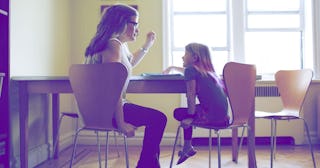 Mother helping daughter with homework