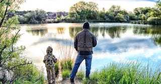 Father and child by lake