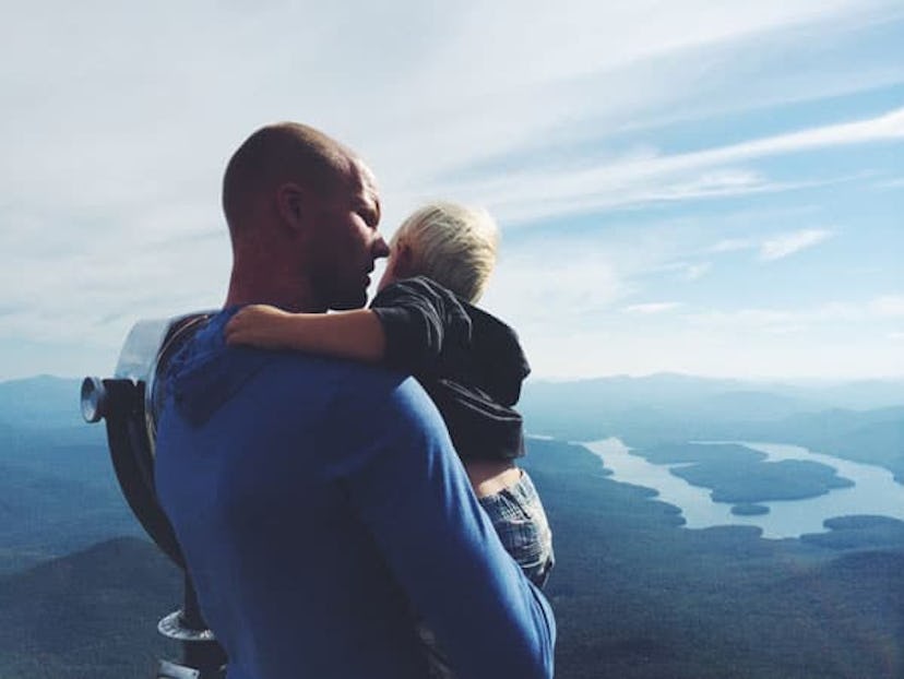 Father and child by lake