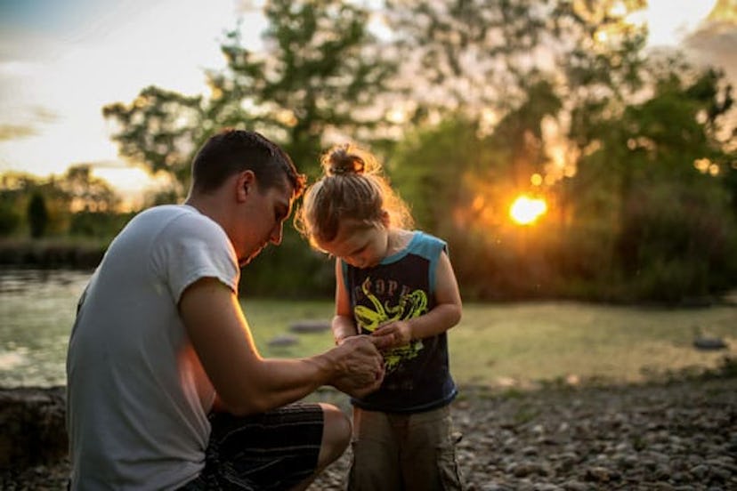 Father and child by lake