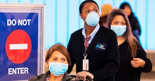 Passengers wear face masks to protect against the COVID-19