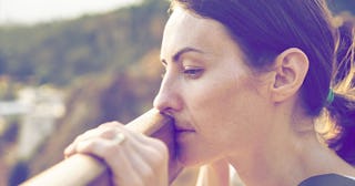 sad woman looking over fence