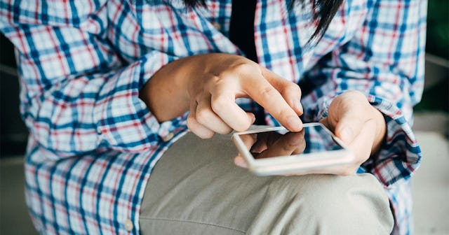 person typing on smart phone