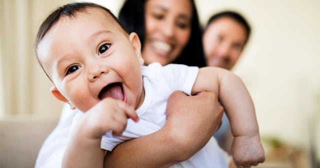 A young mother and father spending time together with their son indoors.