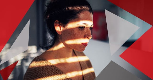 sad woman in her apartment, with a sun on her face, that is breaking through the window blinds
