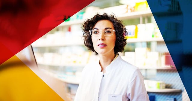 Chemist assisting costumer at the checkout counter