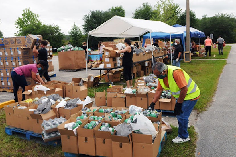 Volunteers prepare food donations from the Second Harvest Food Bank of Central Florida for distribut...