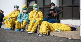 Health care workers take a break from testing patients for Covid-19