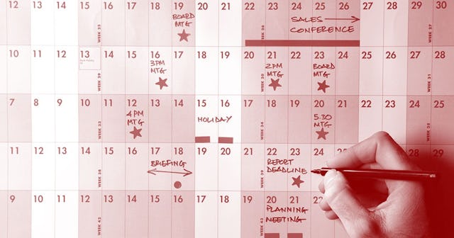 planner and hand holding pen