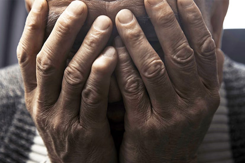 man covers his face with hands