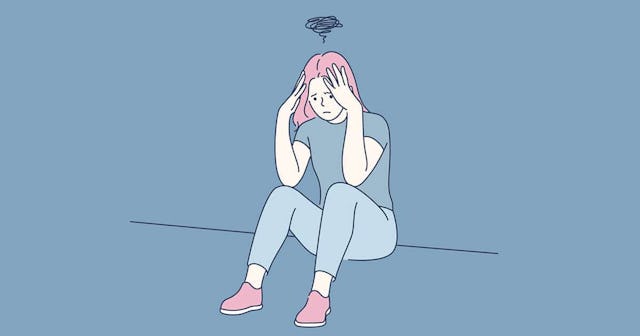 Frustrated woman sitting on floor at home.