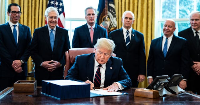 U.S. President Donald Trump signs H.R. 748, the CARES Act in the Oval Office of the White House on M...