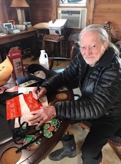 Willie Nelson signing face mask