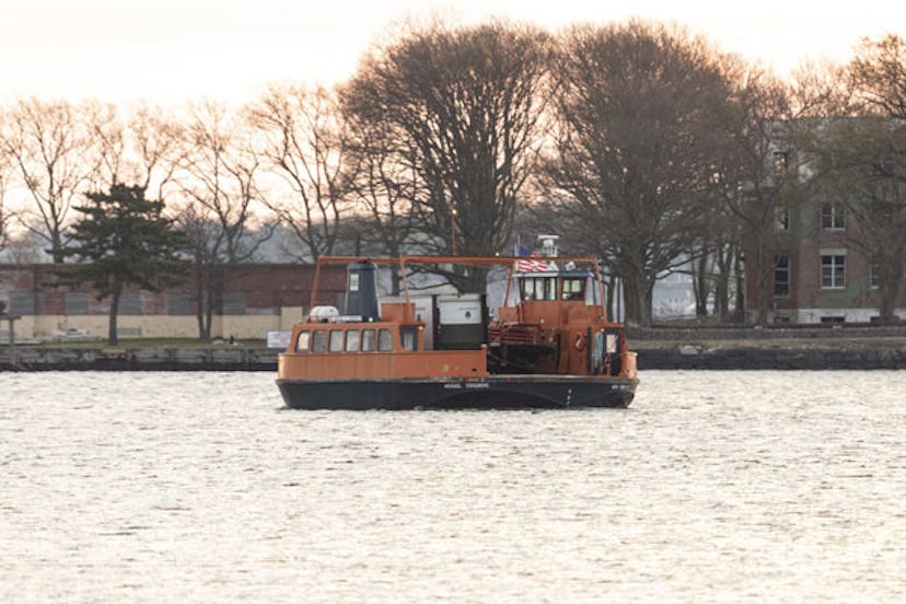 Ferry carrying Special Operation Medical Examiner refrigerated truck move to Hart Island, where uncl...