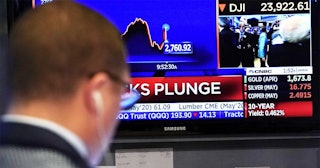 Traders work on the floor during the opening bell on the New York Stock Exchange on March 9, 2020 in...