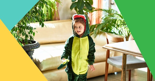 Cute girl in dinosaur costume looking at plants