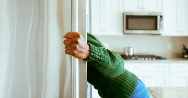 Woman Looks into Refrigerator for Healthy Snack