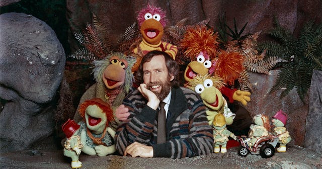 American puppeteer and filmmaker Jim Henson (1936 - 1990) with some of the Muppet cast from the chil...