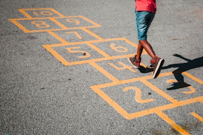 A child takes their turn moving down the board.