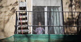 A girl in confinement looks out the window on April 17, 2020 in Barcelona, Spain.