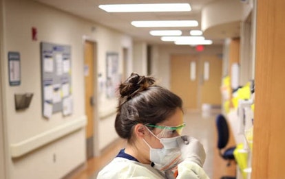 Nurses in the COVID-19 unit of MedStar St. Mary's Hospital check the fit of protective equipment bef...