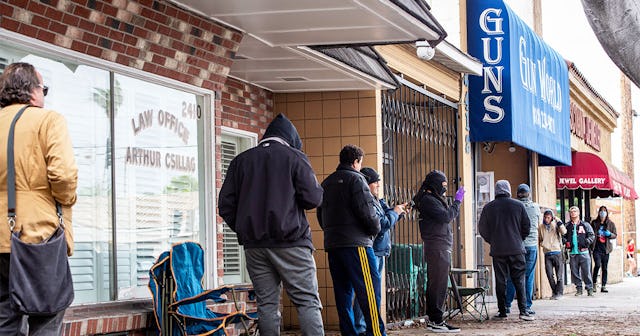 Shoppers wait in line to purchase ammunition and guns
