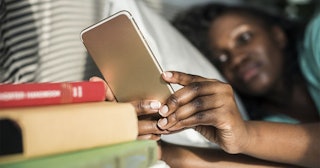 woman using tablet on the bed