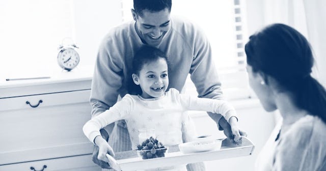 Father and daughter bringing breakfast to mother