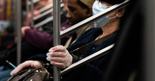 woman wearing a protective mask rides a subway on March 9, 2020 in New York City.