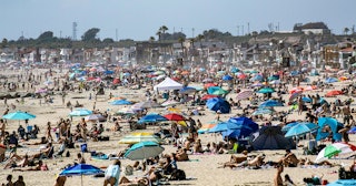 arge crowds gather near the Newport Beach Pier in Newport Beach on Saturday, April 25, 2020 to cool ...