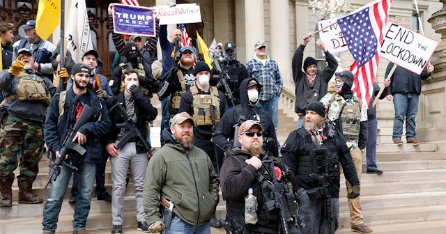People take part in a protest for "Michiganders Against Excessive Quarantine" at the Michigan State ...