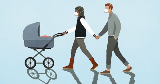 Couple in flu masks holding hands and walking baby in stroller