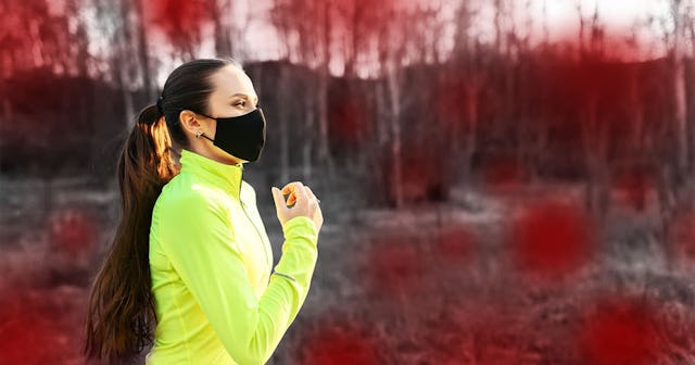 Woman in medical mask is jogging outdoors