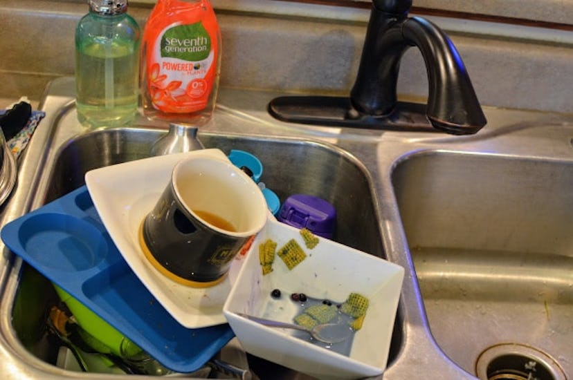 A sink overflowing with dirty dishes