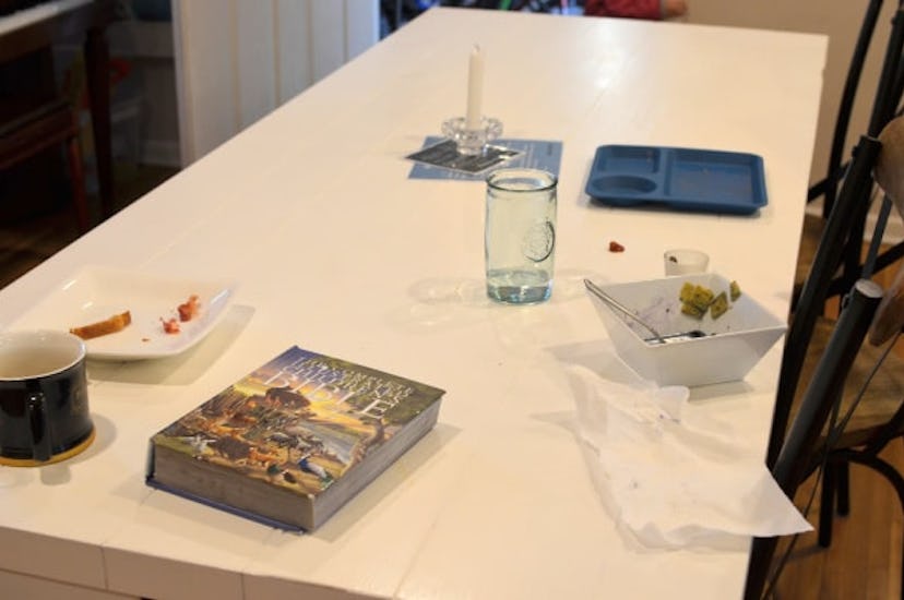 A white table and remnants of breakfast on it