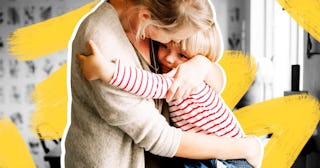 Loving daughter embracing mother while sitting on kitchen counter at home