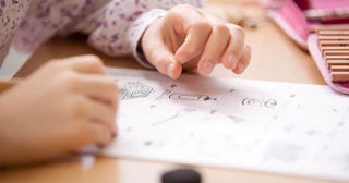 Schoolgirl working on work sheet