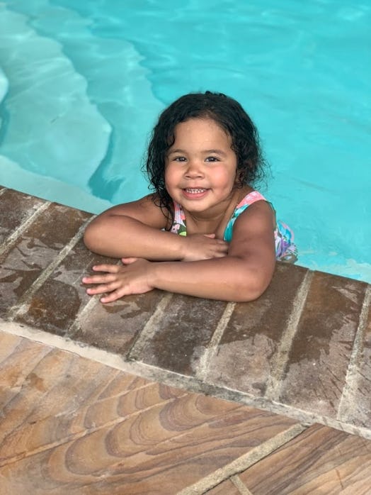 A girl leaning on the edge of the pool