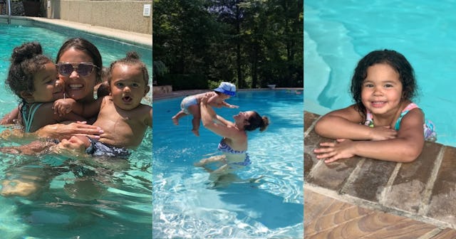 A mother swimming with her kids in a pool