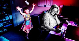 Women working from home in office whilst also looking after her young daugther