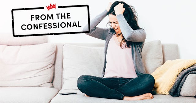 Frustrated Woman With Hand In Hair Sitting On Sofa At Home