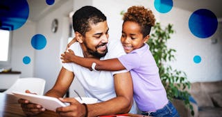 girl doing homework at home, with a help of her father.