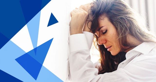 Woman Standing By White Brick Wall