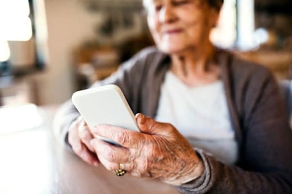 Grandmother at home using smart phone