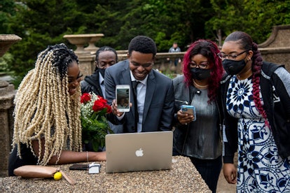 Andre Rambana, 23, C, introduces his future mother-in-law, Yanique Dunn, pictured live on phone, to ...