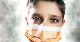 Little boy wearing anti virus mask staying at home